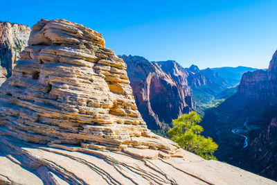 Scenic view of mountains against clear blue sky