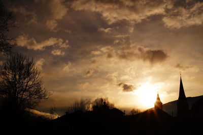 Low angle view of silhouette trees against sky