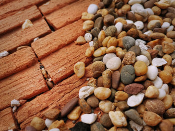 Small pebble stones on tiled brick floor