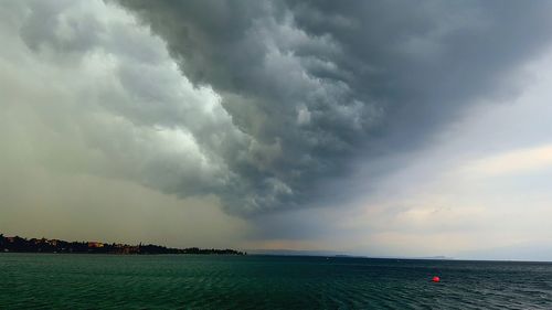 Scenic view of sea against cloudy sky