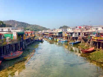 Boats in canal along buildings