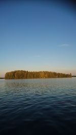 Scenic view of lake against clear blue sky