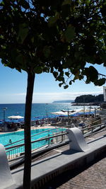 Scenic view of swimming pool by sea against sky