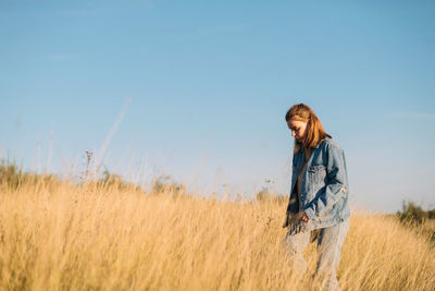 Man standing on field against sky