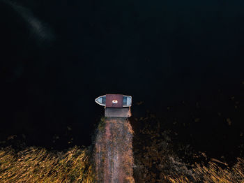 Close-up of illuminated lighting equipment on field at night