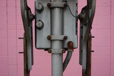 Close-up of pipe hanging on metal wall
