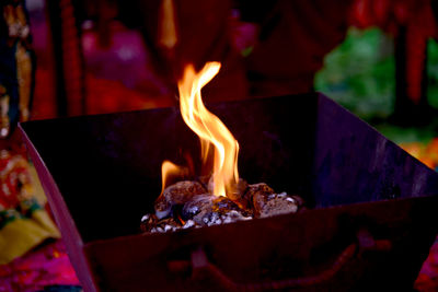 Close-up of burning candles on wood