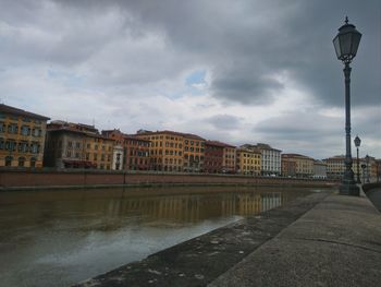 Street by buildings against sky