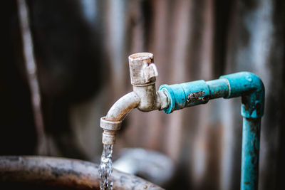 Close-up of water falling from tap