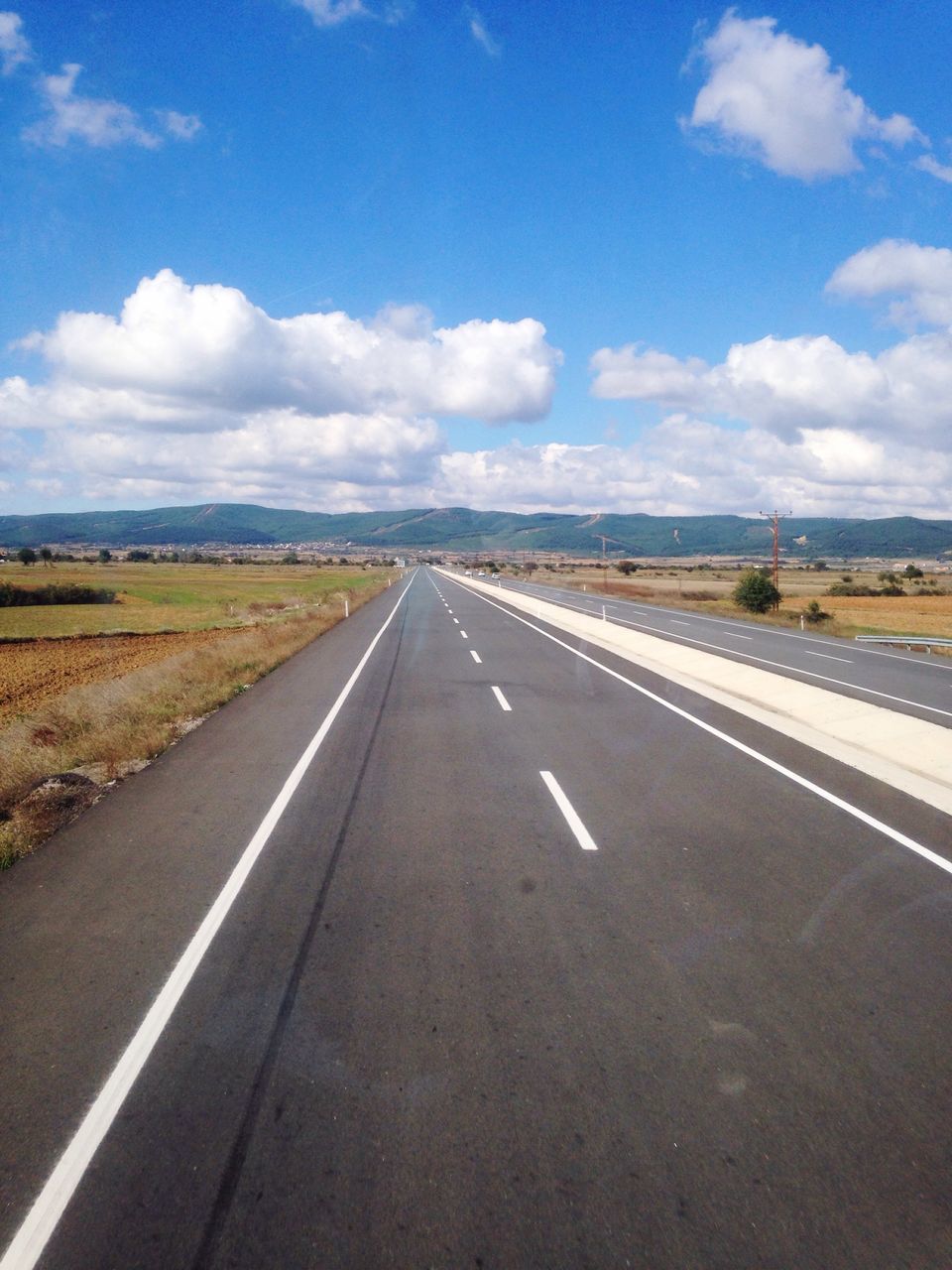 the way forward, transportation, diminishing perspective, road, road marking, vanishing point, sky, asphalt, cloud - sky, country road, landscape, empty, empty road, long, cloud, surface level, blue, dividing line, tranquil scene, highway