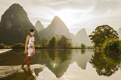Beautiful woman walking through the river li in yangshuo