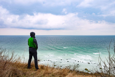 Man at coast. boulders and white rocks at the coast of cape arkona