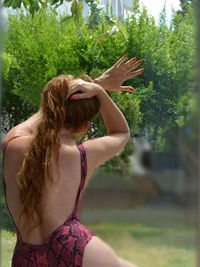 Rear view of woman standing in park