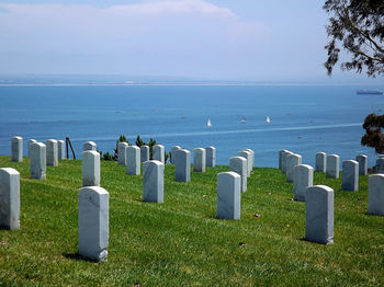Row of cemetery against sea and sky