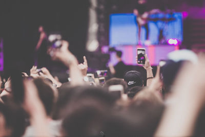 People photographing at music concert