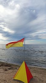 Sand and flag by the sea