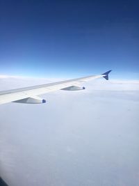 Airplane flying over blue sky