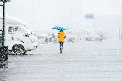 Man with umbrella on snow