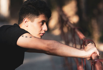 Side view of young man looking away