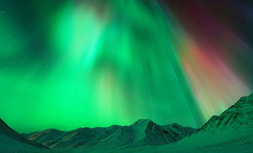 Scenic view of mountains against sky at night