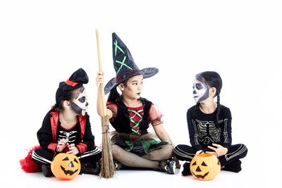 Children playing with toy against white background
