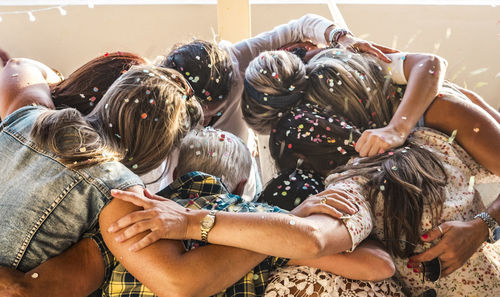 High angle view of friends huddling in party