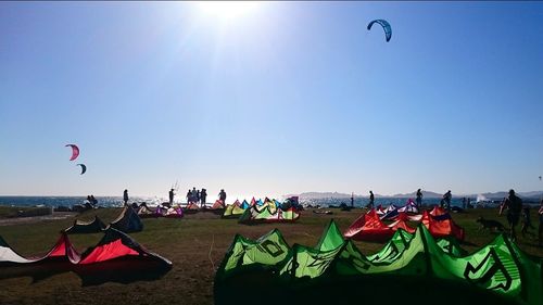 People on beach against clear sky