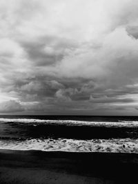 Scenic view of sea against cloudy sky