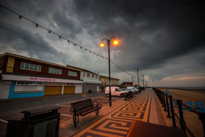 Street light against cloudy sky