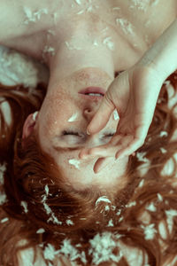 Close-up young woman with freckles on face