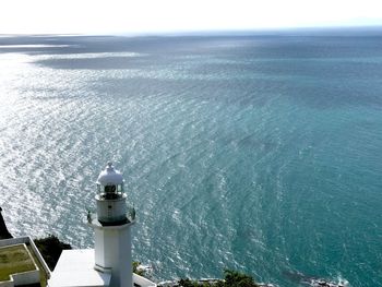 High angle view of lighthouse by sea against sky