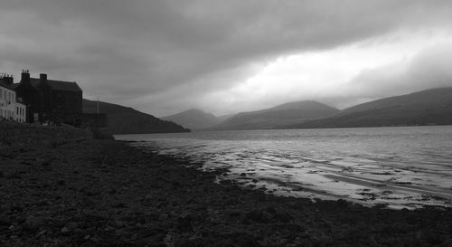 Scenic view of mountains against cloudy sky