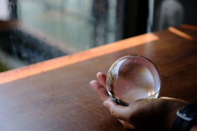 Close-up of hand holding glass bubble