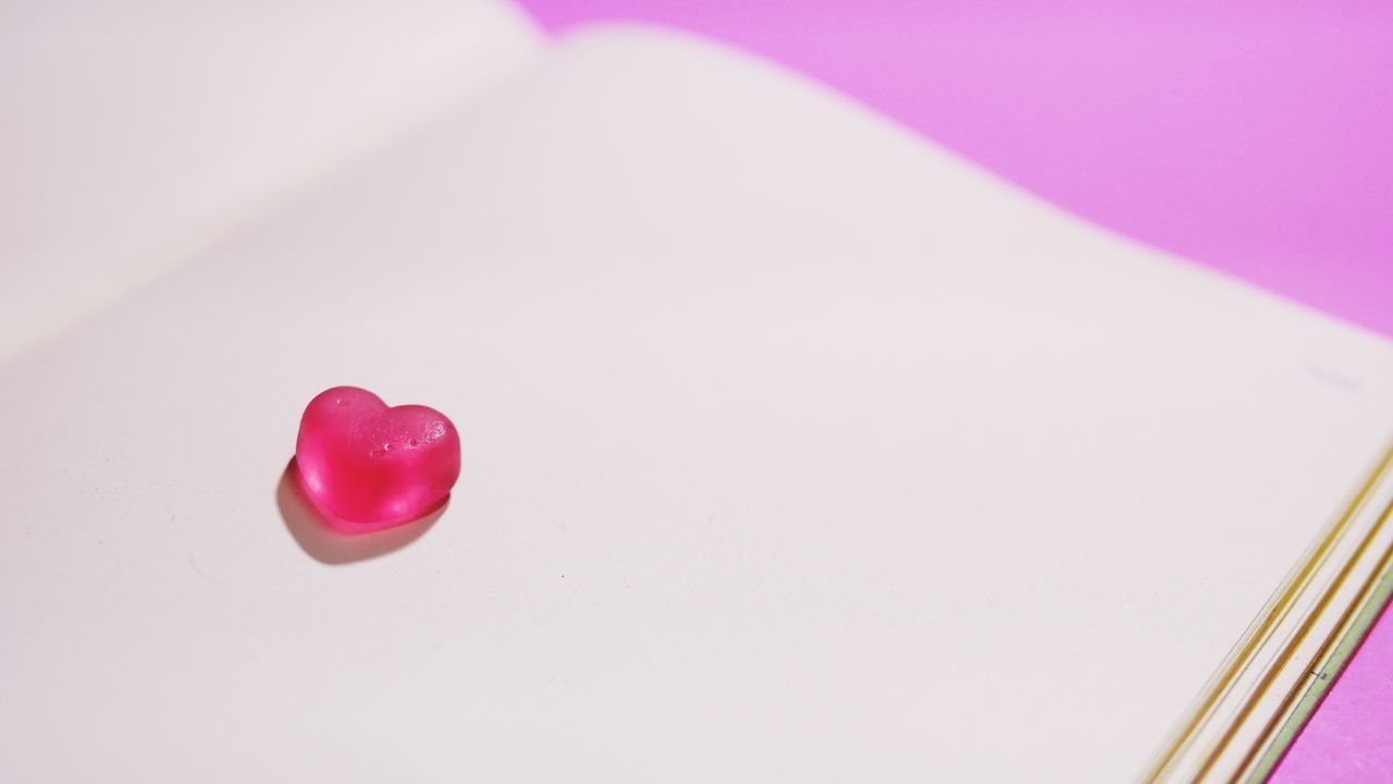 HIGH ANGLE VIEW OF HEART SHAPE ON PINK BACKGROUND