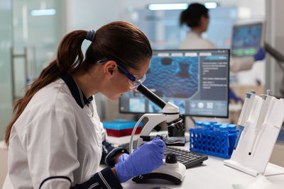 Side view of woman using laptop