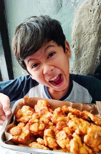 Portrait of boy holding food