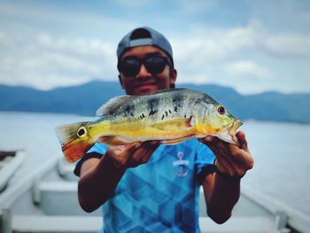 Man holding fish in sea