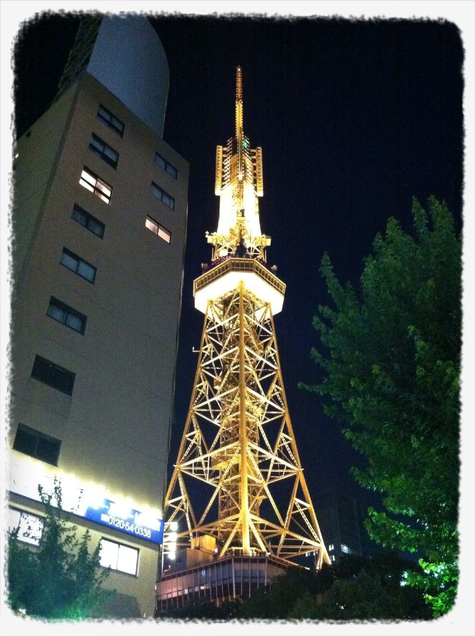 built structure, transfer print, architecture, low angle view, building exterior, tower, auto post production filter, tall - high, night, illuminated, sky, travel destinations, famous place, tree, city, capital cities, eiffel tower, outdoors, communications tower, travel