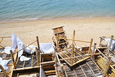 High angle view of wooden tables at beach