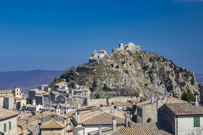 Buildings in town against sky