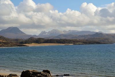 Scenic view of lake against cloudy sky