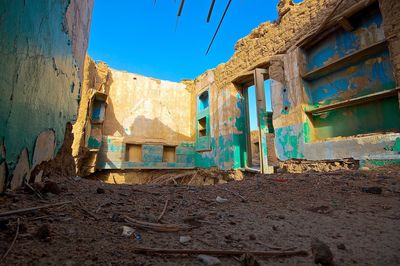 Abandoned building against blue sky