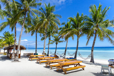 Scenic view of beach against clear blue sky