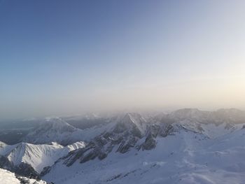 Scenic view of snow covered mountains against sky