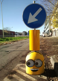 Close-up of road sign against clear blue sky