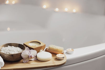 Preparation for spa treatment or home bath procedure. white washbasin in bathroom with accessories