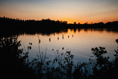 Scenic view of lake against sky during sunset