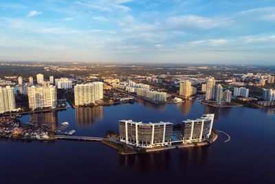 High angle view of river amidst buildings in city against sky