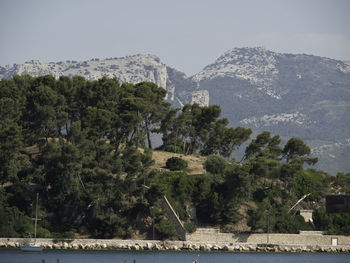 Scenic view of lake and mountains against sky