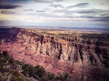Scenic view of mountains against cloudy sky